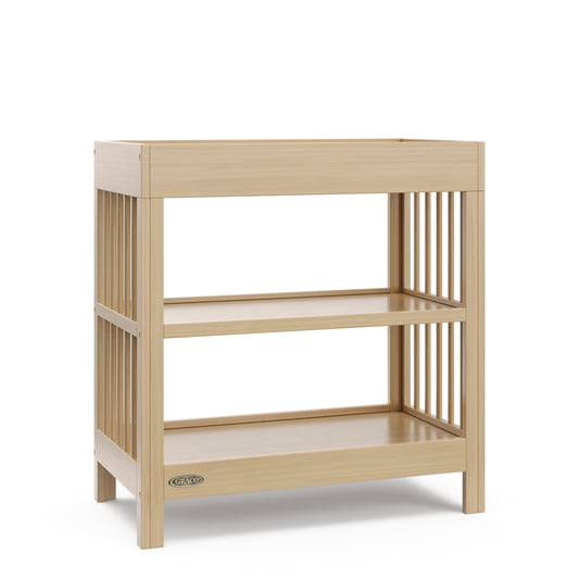 Graco Teddi Changing Table with Water-Resistant Changing Pad (Driftwood) - GREENGUARD Gold Certified, 2 Open Shelves, Includes Bonus Water-Resistant Changing Pad with Safety Strap 🍁 All In One Marketplace Canada